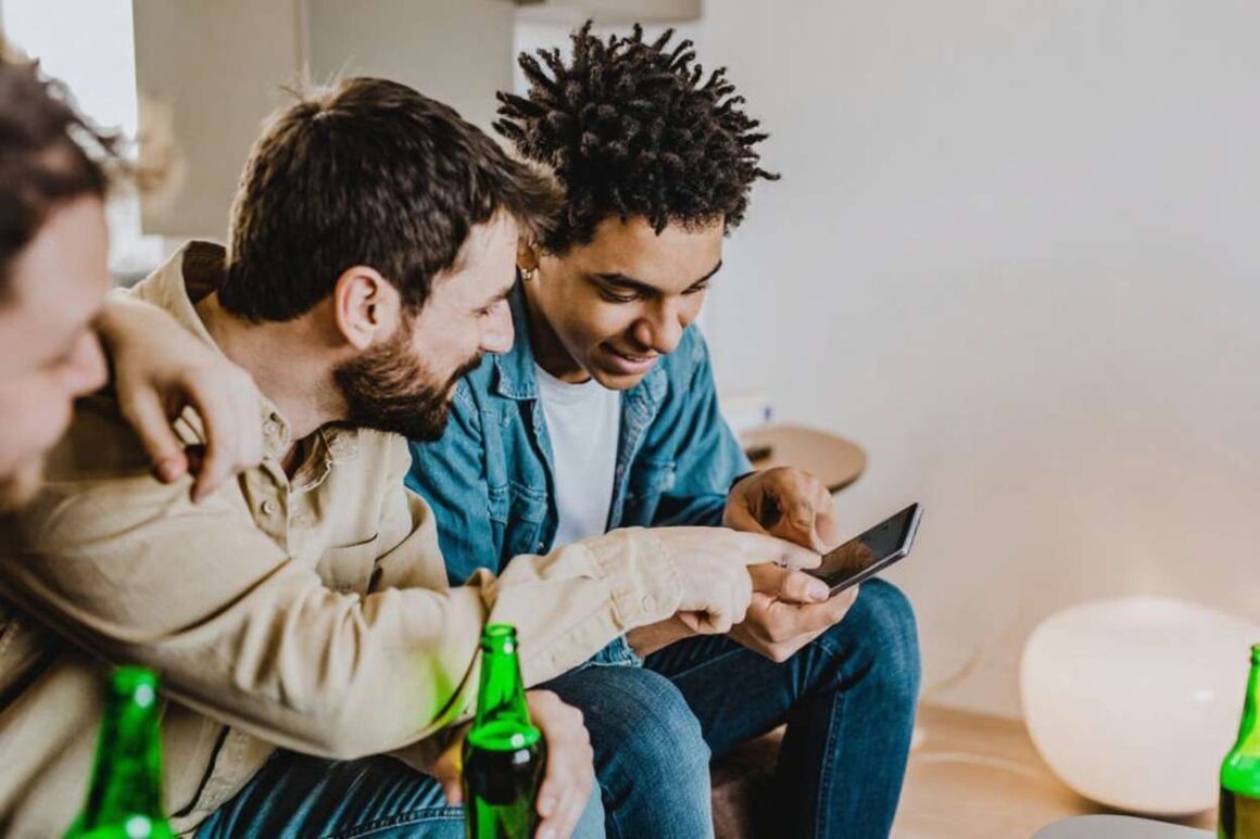 a group of guys using a sports betting app