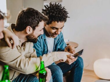 a group of guys using a sports betting app