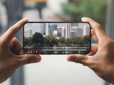 Someone holding a cellphone showing video