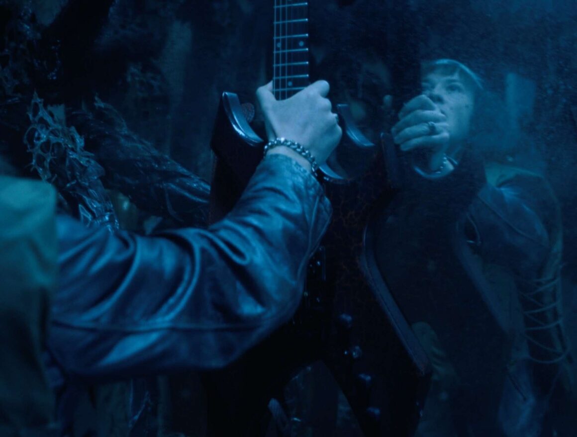 Eddie Munson grabbing his guitar in Stranger Things 4